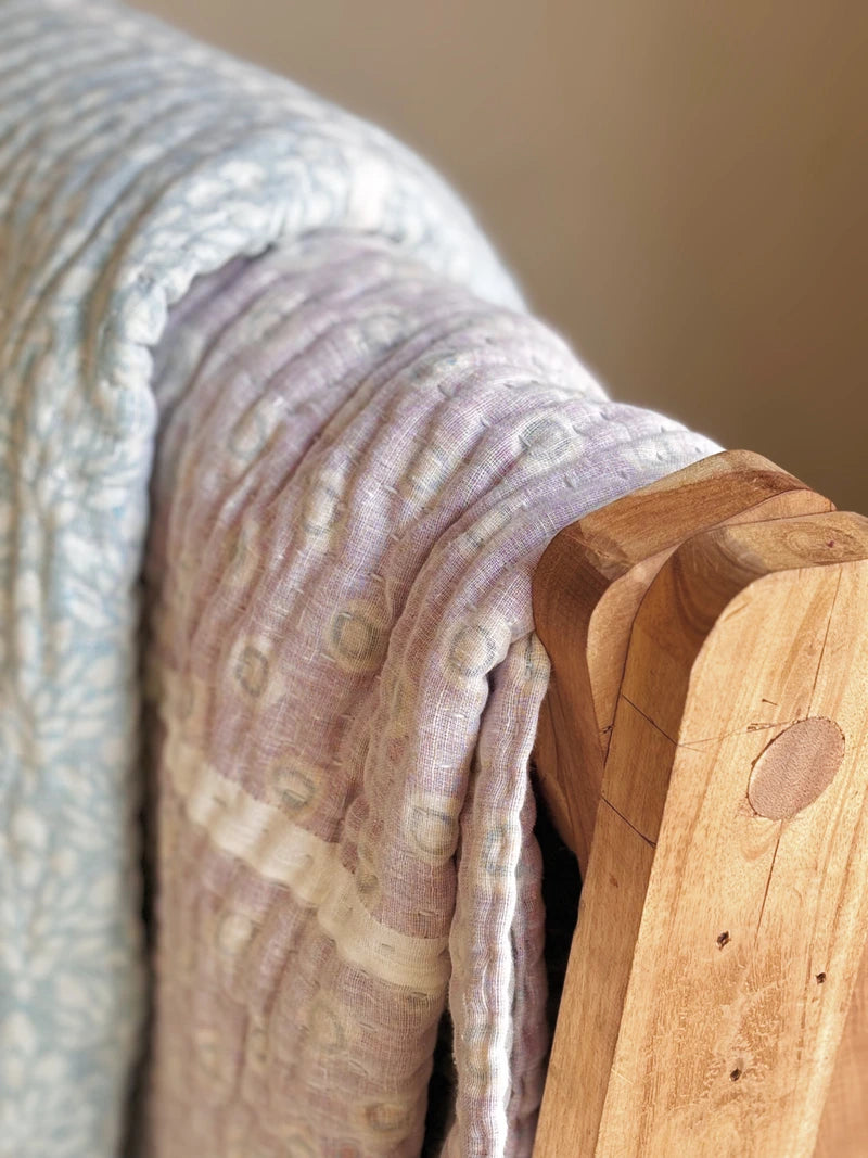 Padded kantha quilt with subtle pattern of traditional sari cloth through sheer white overlay